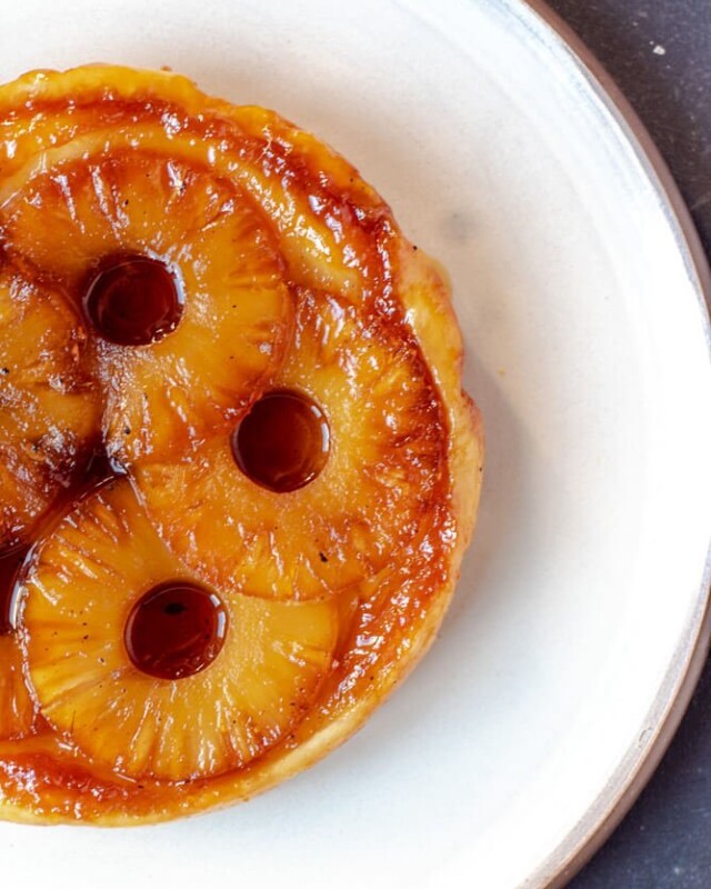 Pineapple tarte Tatin with golden caramelised pineapple rings on crisp puff pastry.