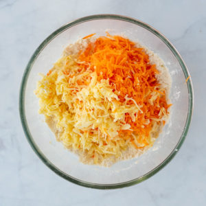 Grated carrot and cheddar cheese added to the flour and butter mixture.